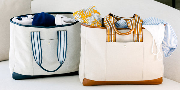The Capri Everyday Tote in Blue and Brown on a white couch